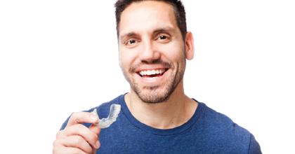 Man getting ready to place his Invisalign tray