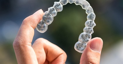 hand holding clear aligner