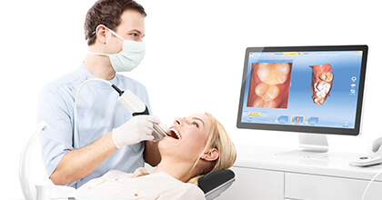 Dentist creating restoration design using CEREC system