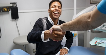 A man shaking hands with his dentist