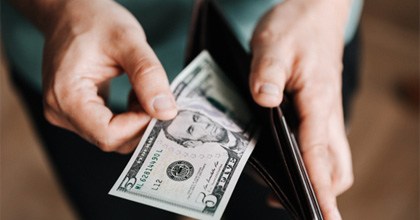 Man pulling cash out of wallet