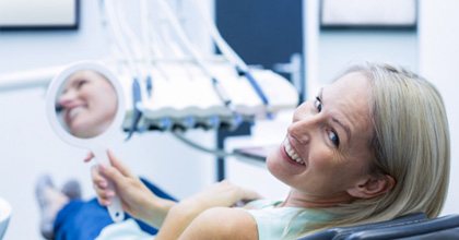 Smiling woman in dentist’s chair
	