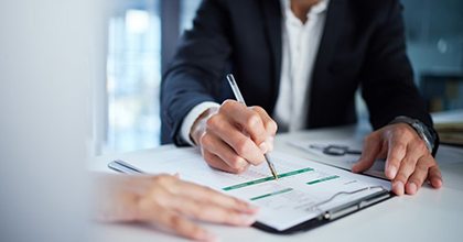Lady smiles while eating salad