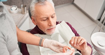 Man with dentures at the dentist