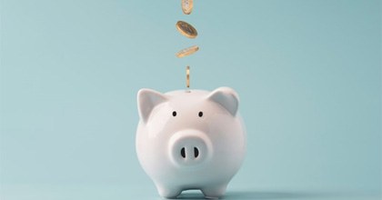 a piggy bank being filled with coins