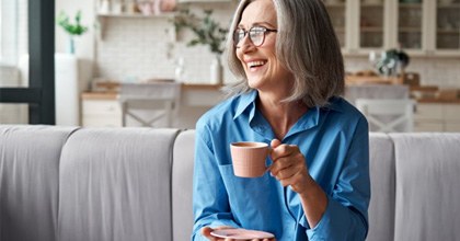 : a woman in Bristol smiling with dentures in the morning