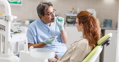 Dentist talking to patient