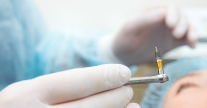 Dentist preparing to place dental implant in patient’s mouth