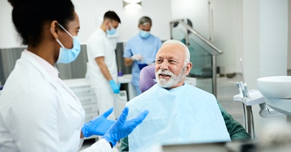 Senior man learning about his candidacy for dental implants