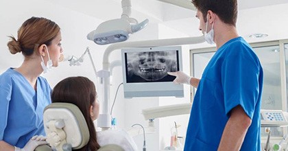 dentist showing a patient their X-rays