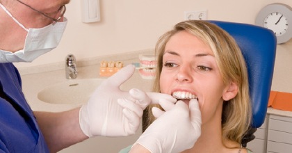 Dentist checking fit of Invisalign tray