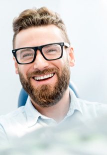 patient smiling while visiting dentist 