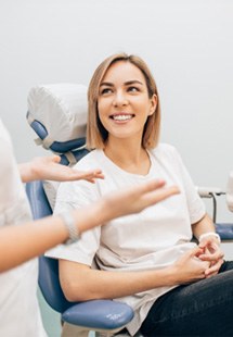 patient smiling while talking to dentist 