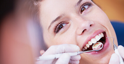 Woman being examined by dentist