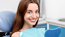 Smiling woman holding mirror