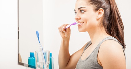 woman brushing teeth