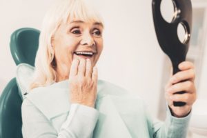 older woman smiling wearing dentures