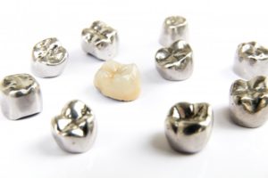 one ceramic dental crown among several metal crowns