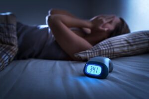 Woman with a nighttime toothache keeping her up